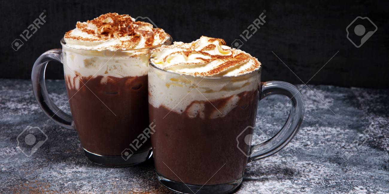 Hot chocolate cocoa with whipped cream for xmas on table.